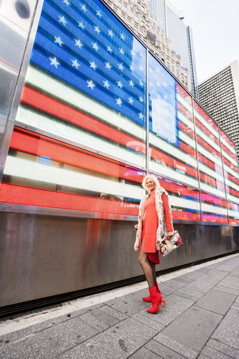 Theodora in New York in front of an American flag display